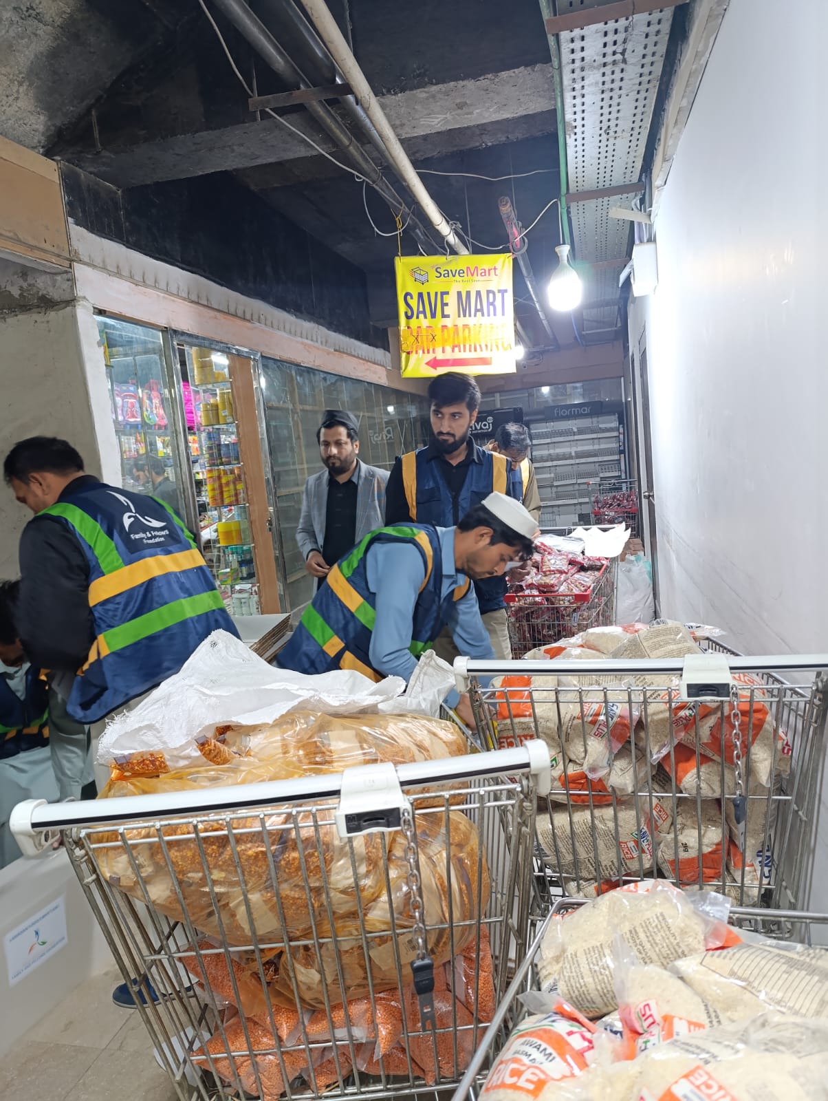 Team loading bulk rice and pulses for Ramadan rations