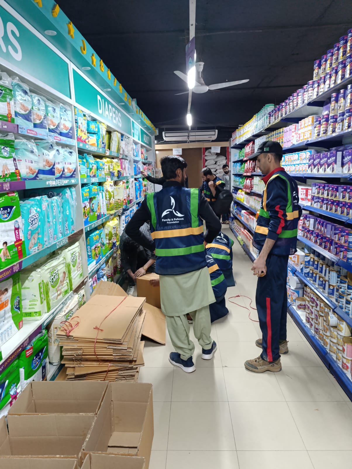 Volunteers packing ration supplies in a store aisle