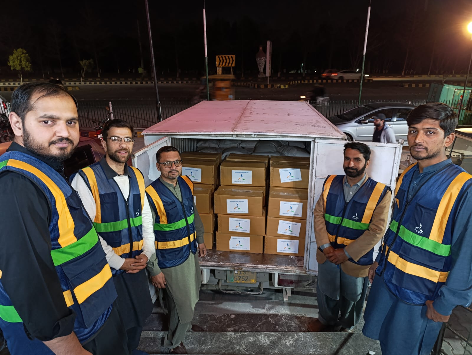 Volunteers with ration boxes loaded for delivery